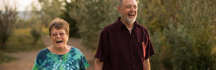 Mary and Jim smiling on a walk outside