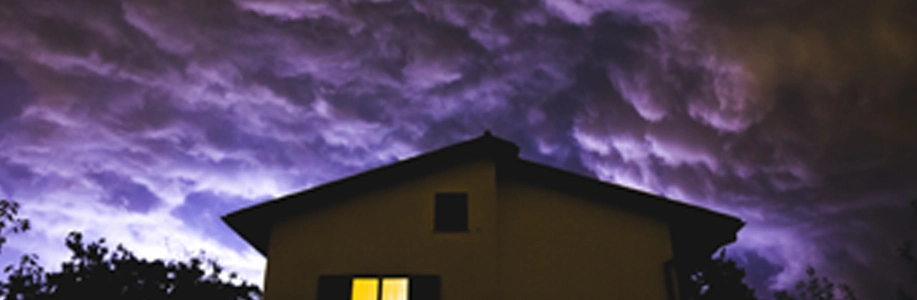 Spooky purple clouds behind house