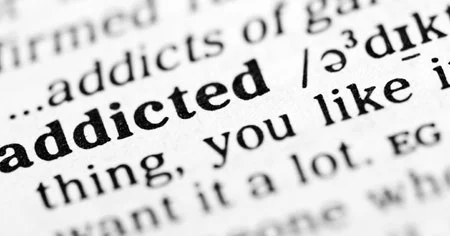 Dictionary text with bolded word "addicted"