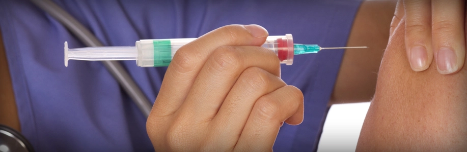 Healthcare worker holding shot