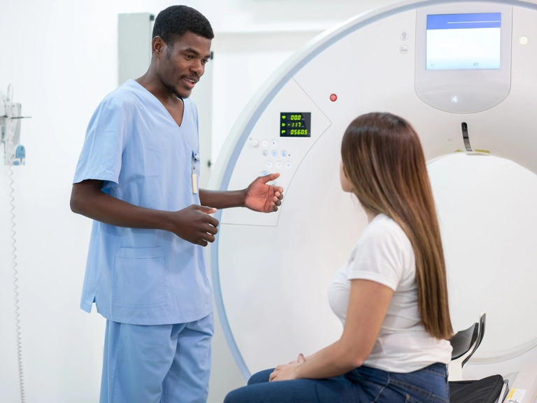 technician explaining CT scan to patient